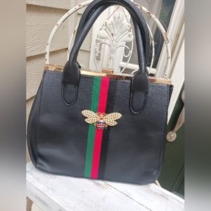 Embellished bee handbag.
